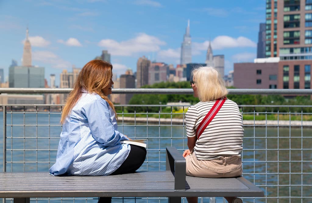 Elsa Carrasco in conversation with a woman
